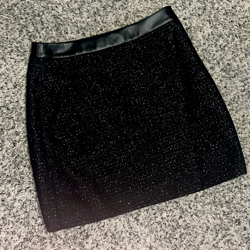 NWOT. Woman’s black sparkling mini skirt from DKNY. Size 6.